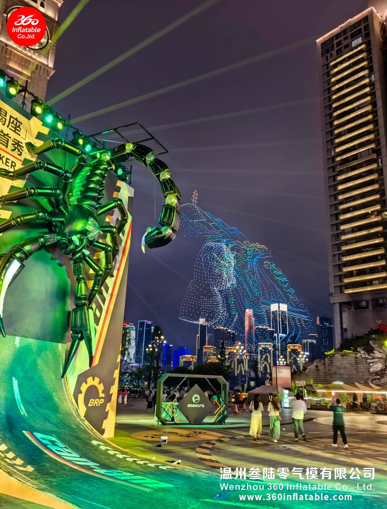Close-up of the mechanical scorpion inflatable illuminated in green light, with a massive drone-formed Scorpio constellation in the background.